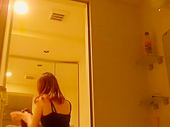 Asian woman undressing ans showering