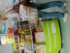 Blonde MILF in tight jeans pants at supermarket