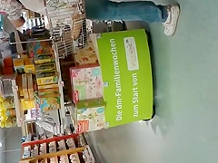 Blonde MILF in tight jeans pants at supermarket