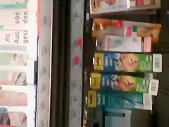 Blonde MILF in tight jeans pants at supermarket