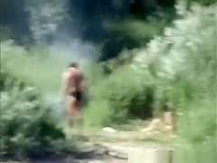 Naturist couple spied between the bushes having sex