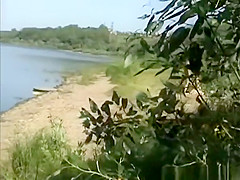 Naturist couple spied between the bushes having sex
