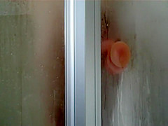 Peep her ride the sticky dildo in a shower