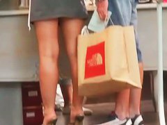 Tight skirts in the middle of the crowd in a shop