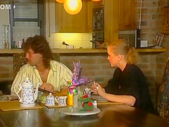 Two Stunning German Chicks Sharing A Loaded Cock On The Kitchen Table