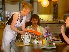 Two Stunning German Chicks Sharing A Loaded Cock On The Kitchen Table