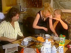 Two Stunning German Chicks Sharing A Loaded Cock On The Kitchen Table