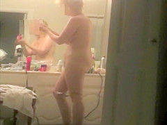 Wife applying skin lotion after a shower