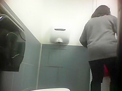 Woman squatting over toilet and pissing