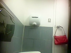Woman squatting over toilet and pissing